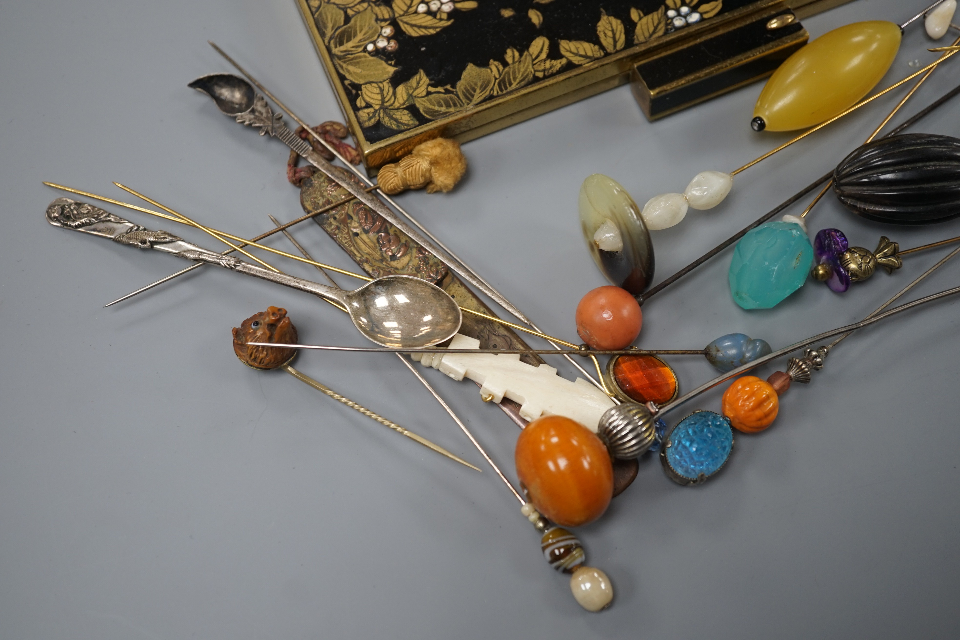 A quantity of hat pins and a compact